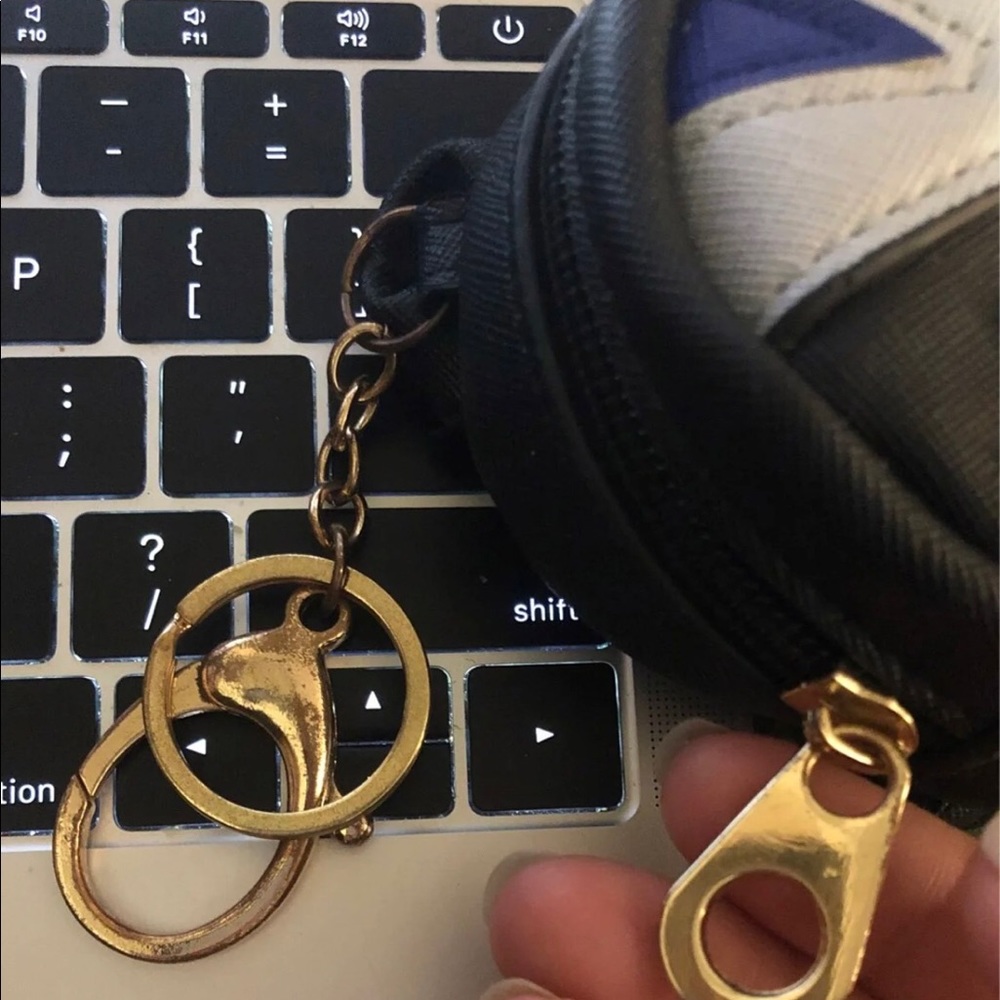 Cute and Useful wallet,or bag charm!  Notice some color change on the hardware.